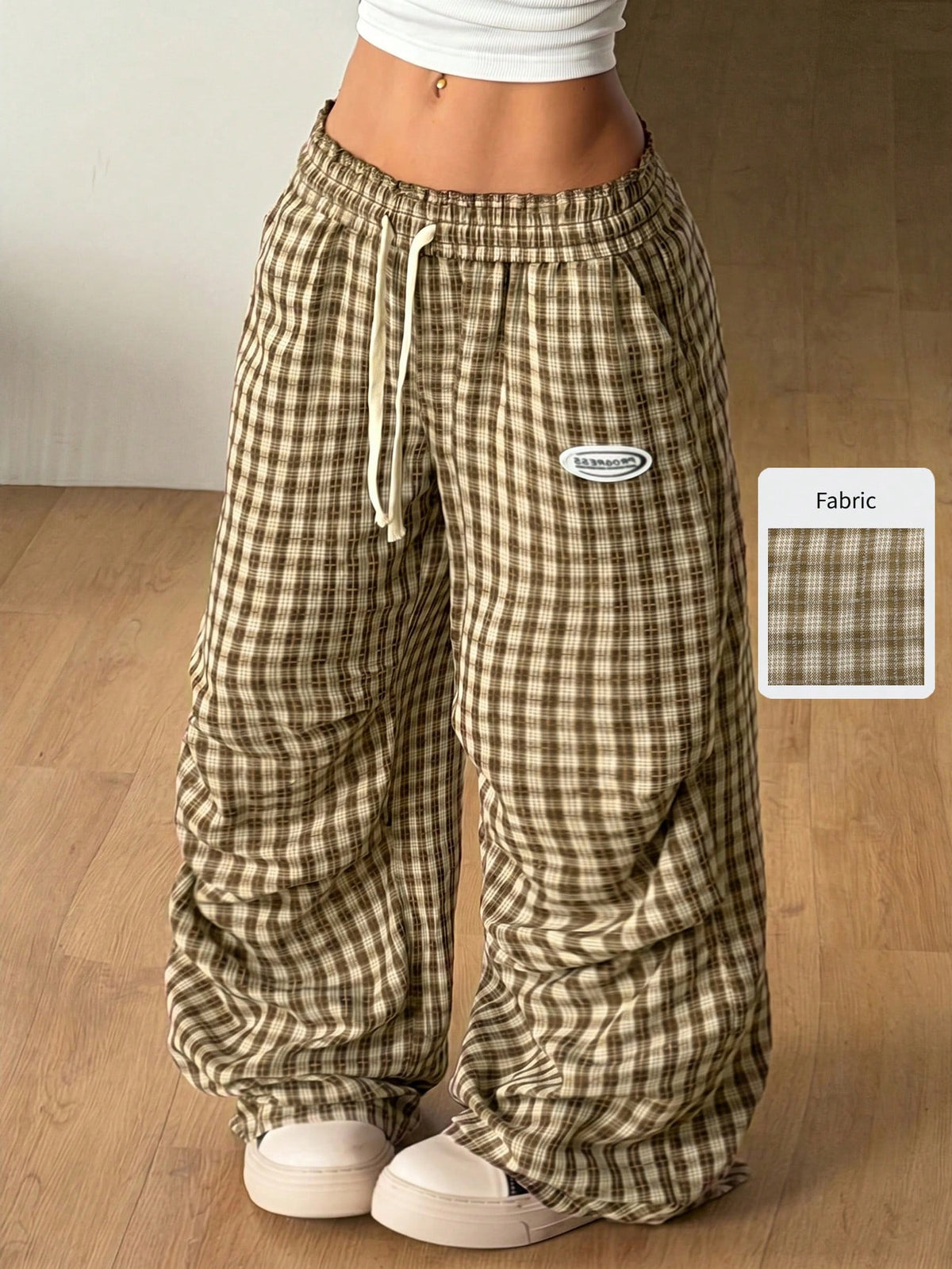 Women's black and white striped wide leg pants featuring an elastic drawstring waistband, side pockets, and a loose straight leg fit.
