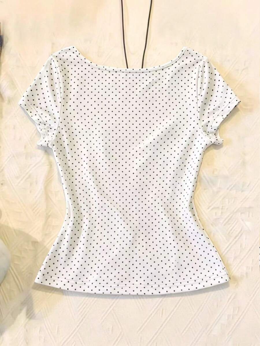 Women's polka dot short sleeve raglan t-shirt with a twist front detail and contrast collar.