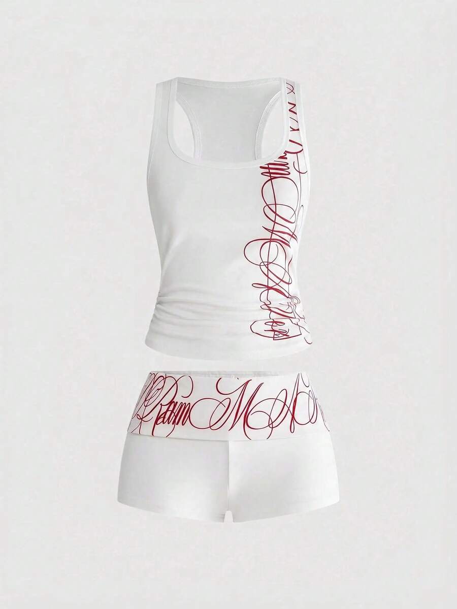Punk-inspired two-piece set with a fitted scoop neck slogan tank top featuring cross and rhinestone details paired with ultra low waist mini shorts.