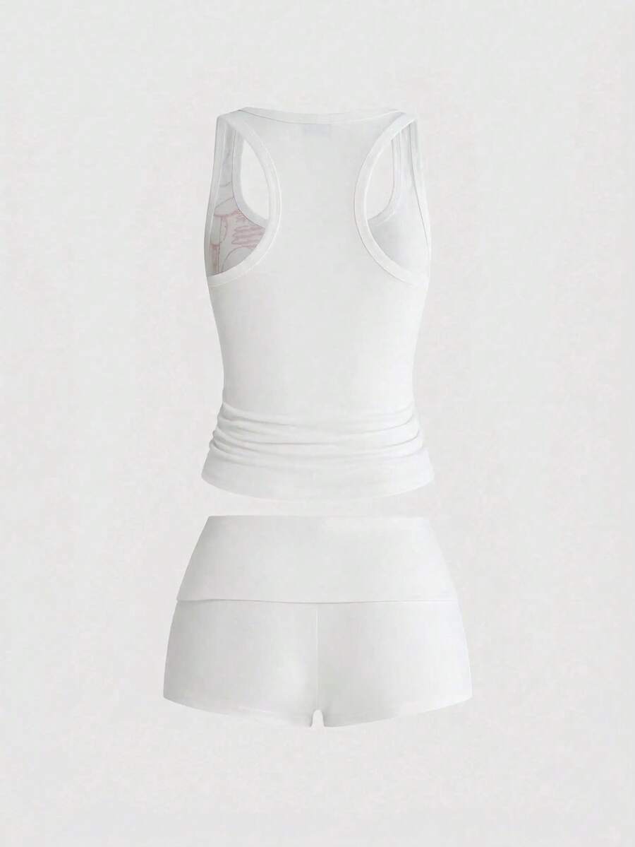 Punk-inspired two-piece set with a fitted scoop neck slogan tank top featuring cross and rhinestone details paired with ultra low waist mini shorts.