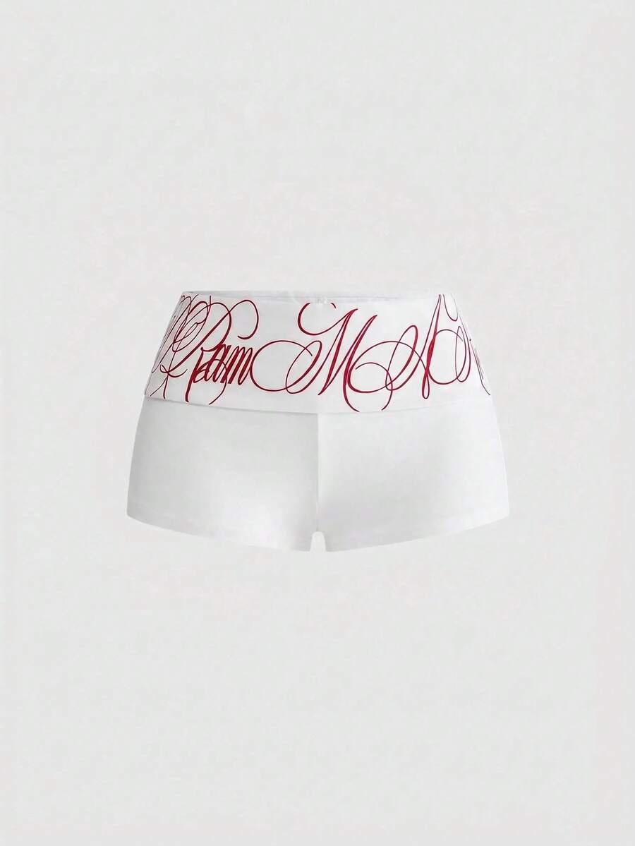 Punk-inspired two-piece set with a fitted scoop neck slogan tank top featuring cross and rhinestone details paired with ultra low waist mini shorts.