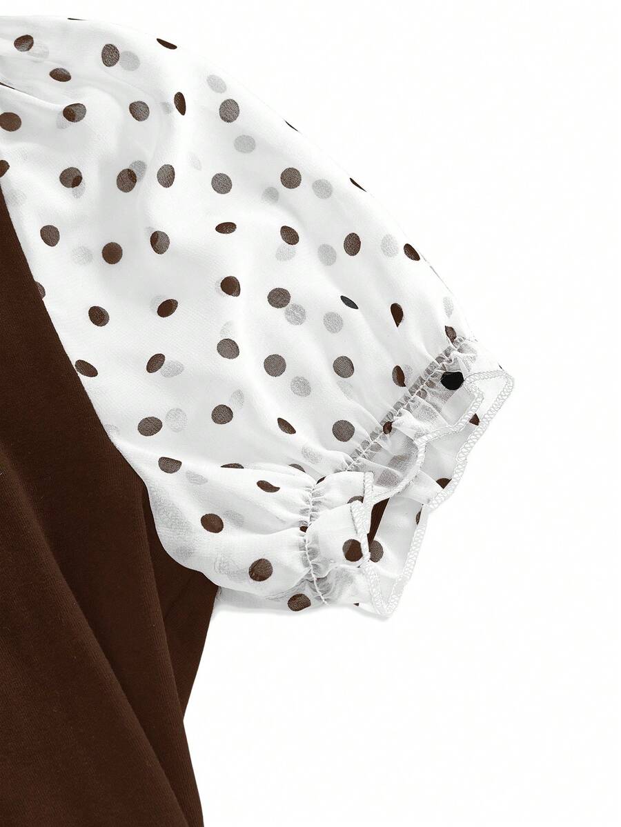 Women's black short puff sleeve graphic print t-shirt featuring a sweetheart neckline and knot detail.