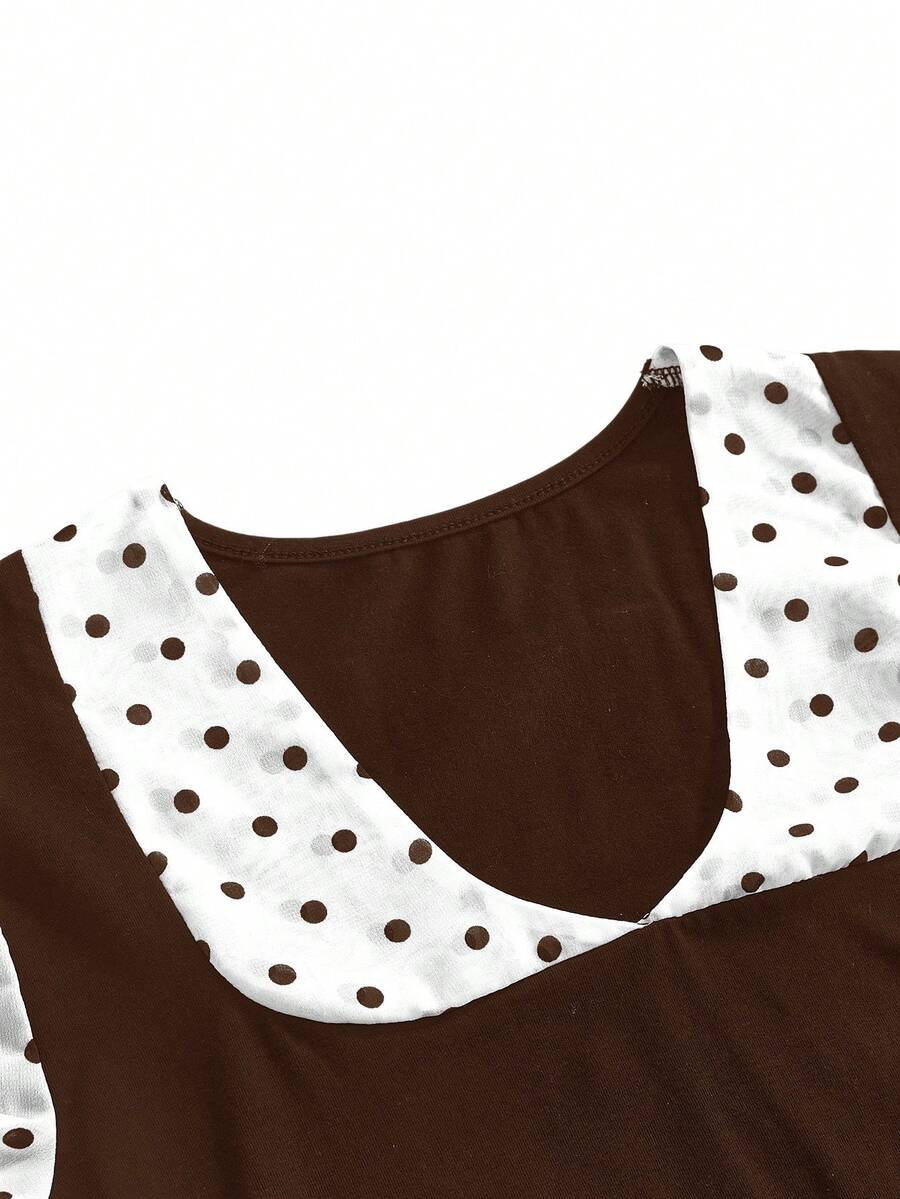 Women's black short puff sleeve graphic print t-shirt featuring a sweetheart neckline and knot detail.