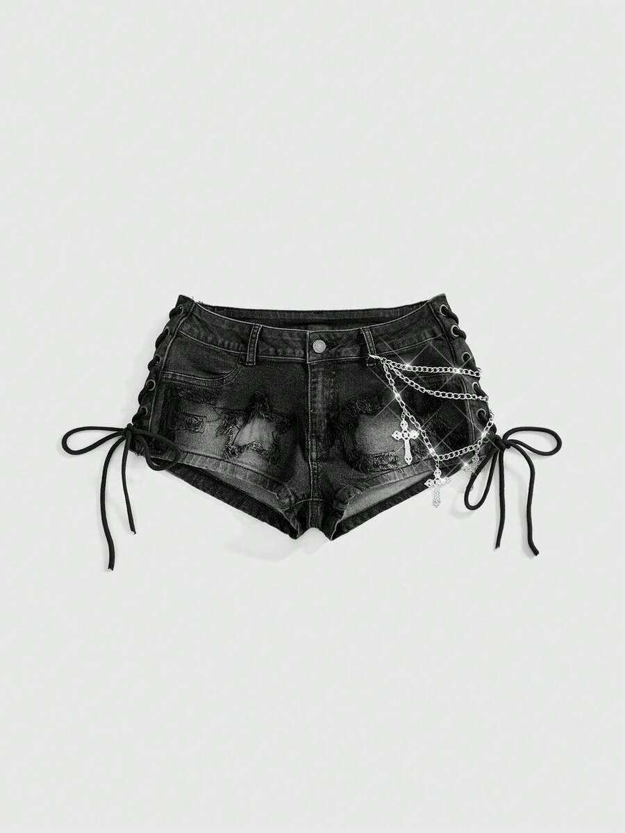 Women's Y2K low waist camo mini skort shorts featuring lace-up knot details, grommet eyelets, graphic lettering pattern, and a zipper fly.