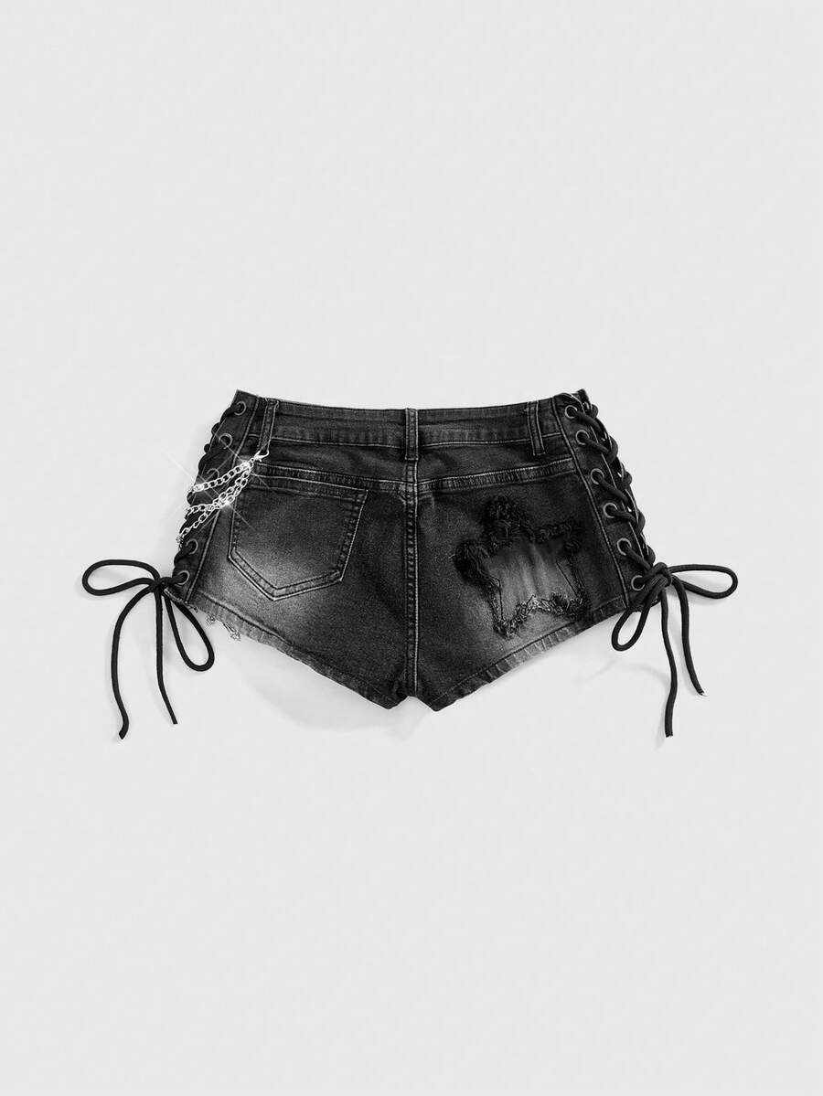 Women's Y2K low waist camo mini skort shorts featuring lace-up knot details, grommet eyelets, graphic lettering pattern, and a zipper fly.