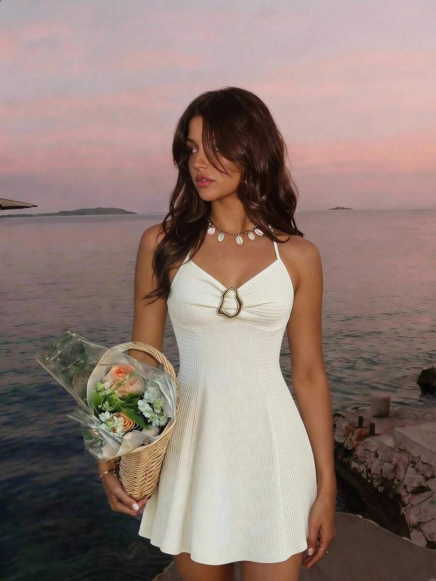 Women's apricot halter mini dress with backless knot and ring detail, sleeveless cami style, flared hem, and boho vacation look