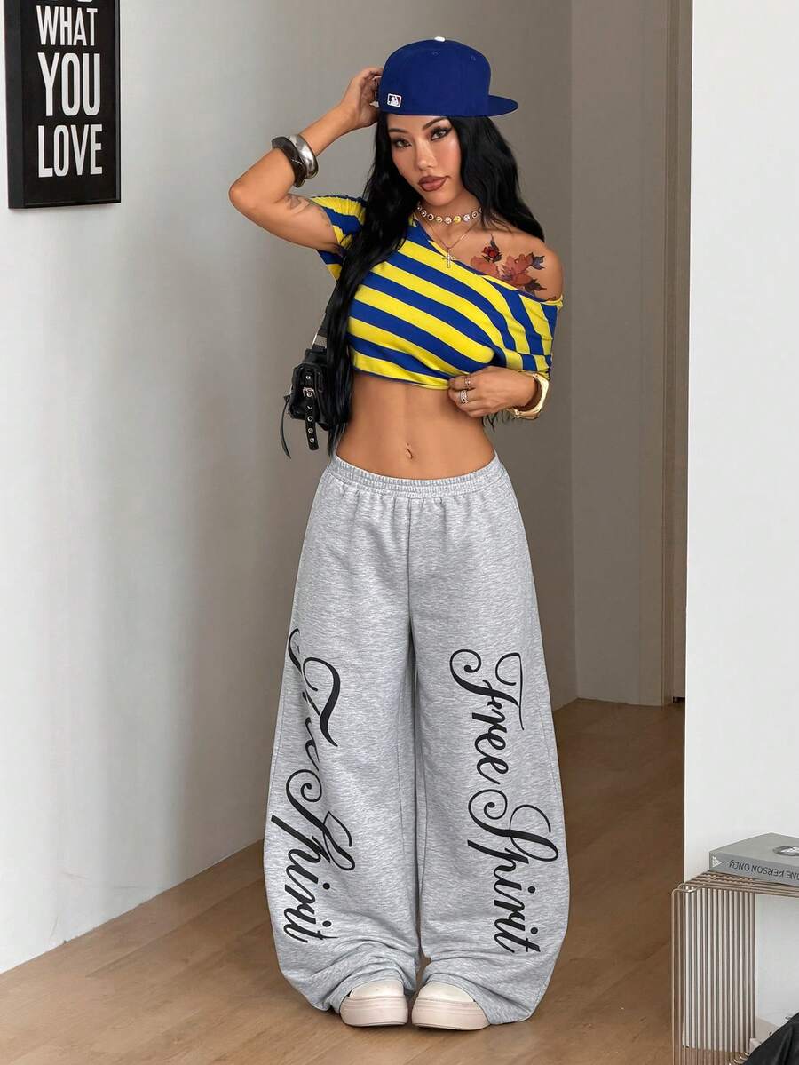 Women's loose fit wide leg graphic sweatpants in light grey with an elastic drawstring waistband