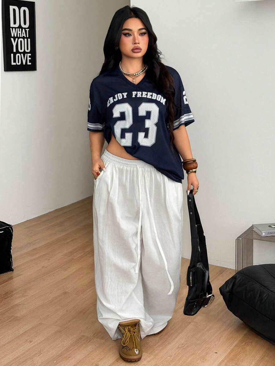Navy blue plus size mesh baseball jersey t-shirt featuring a V-neck, raglan half sleeves, and sporty letter detailing.
