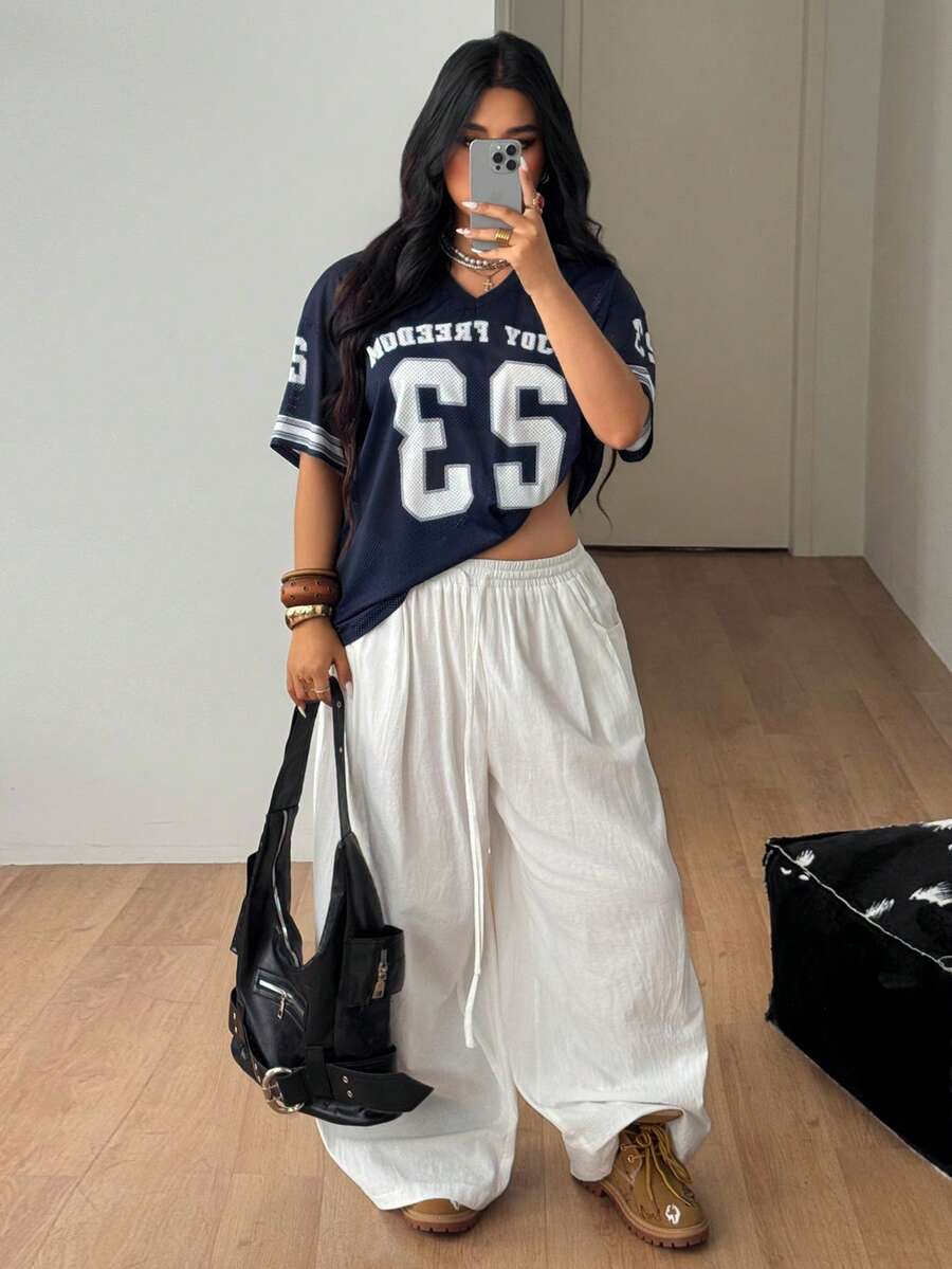 Navy blue plus size mesh baseball jersey t-shirt featuring a V-neck, raglan half sleeves, and sporty letter detailing.