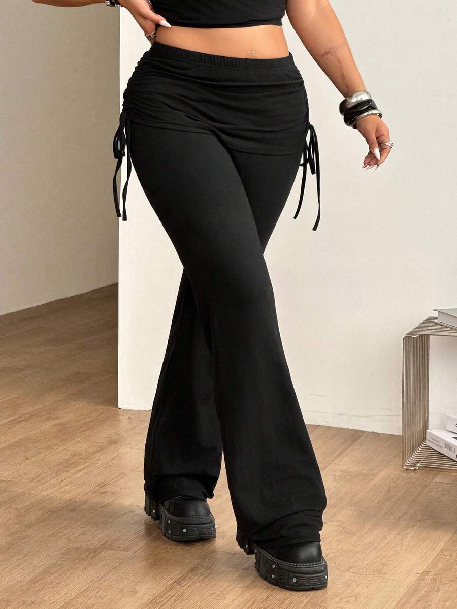 Women's striped flare leg pants featuring a mid-rise waist, slim fit thigh, and ruched side drawstring detail in stretch knit fabric.