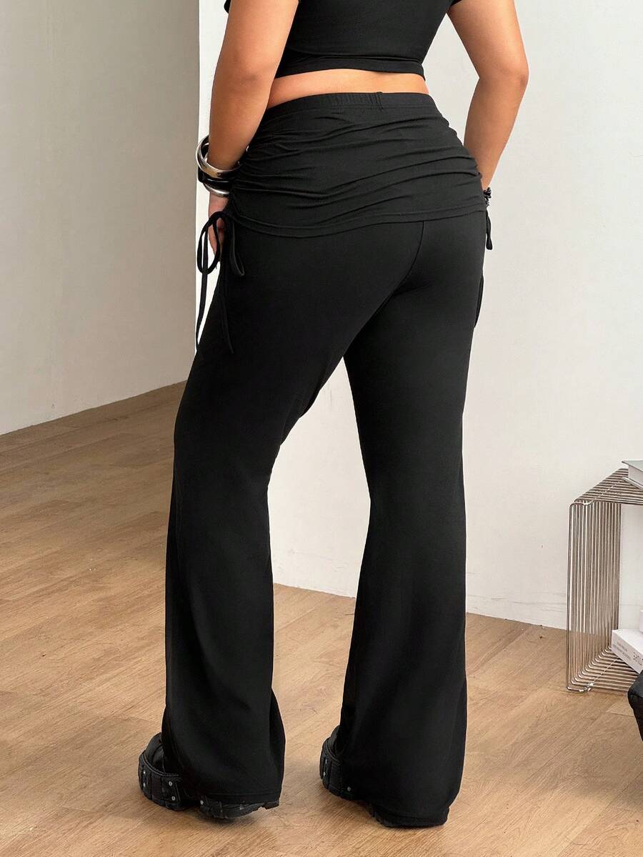 Women's striped flare leg pants featuring a mid-rise waist, slim fit thigh, and ruched side drawstring detail in stretch knit fabric.
