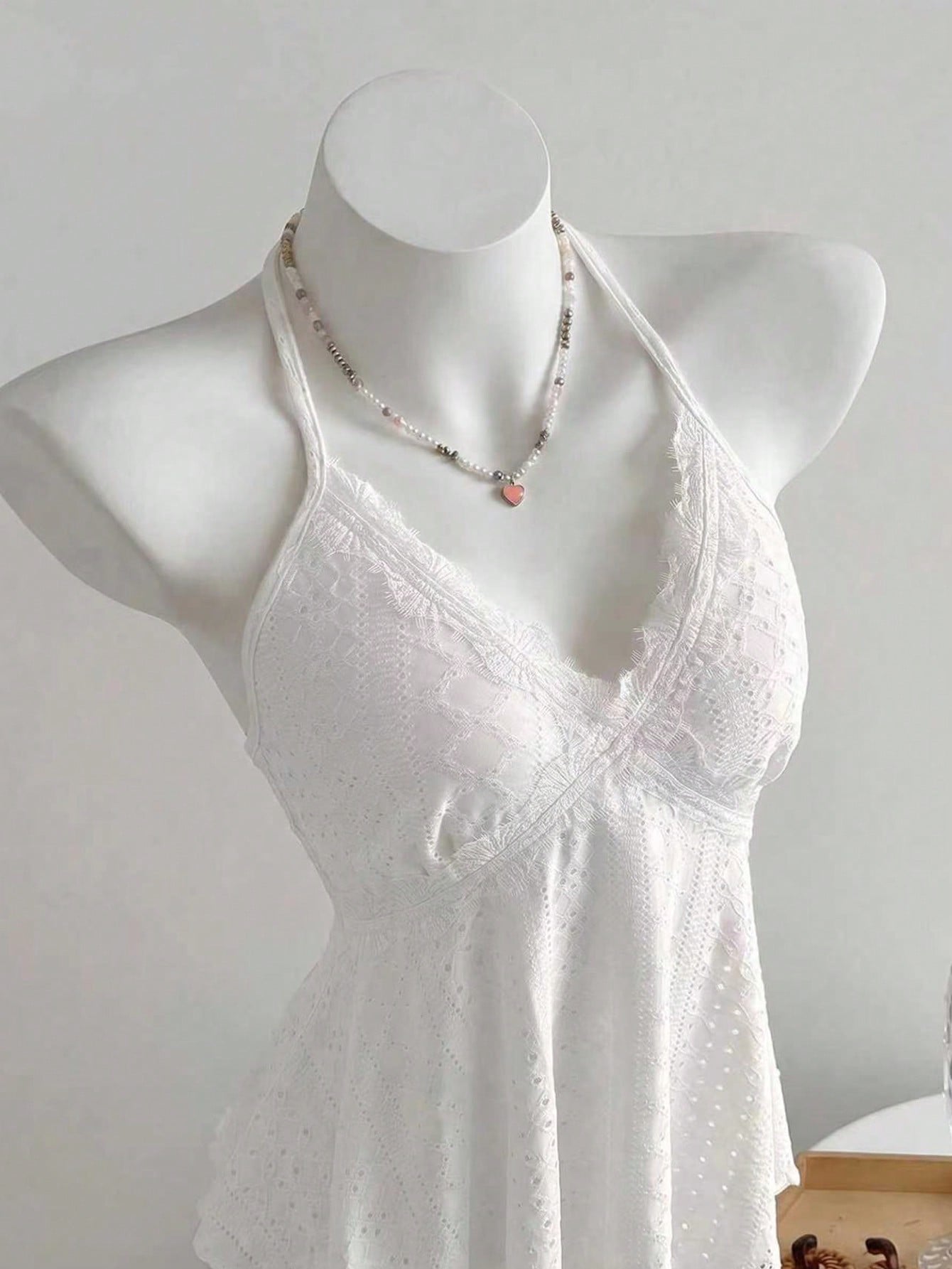 Women's halter crop camisole with textured detail, slim fit, and flared hem for beach vacation and spring or summer wear