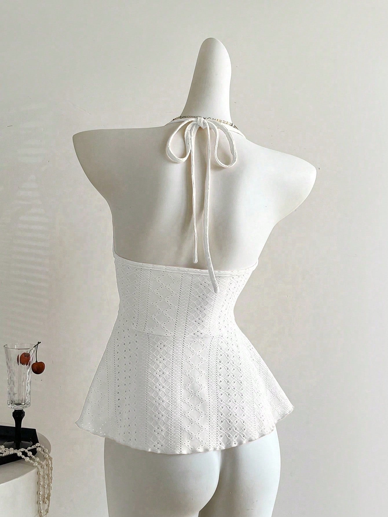 Women's halter crop camisole with textured detail, slim fit, and flared hem for beach vacation and spring or summer wear