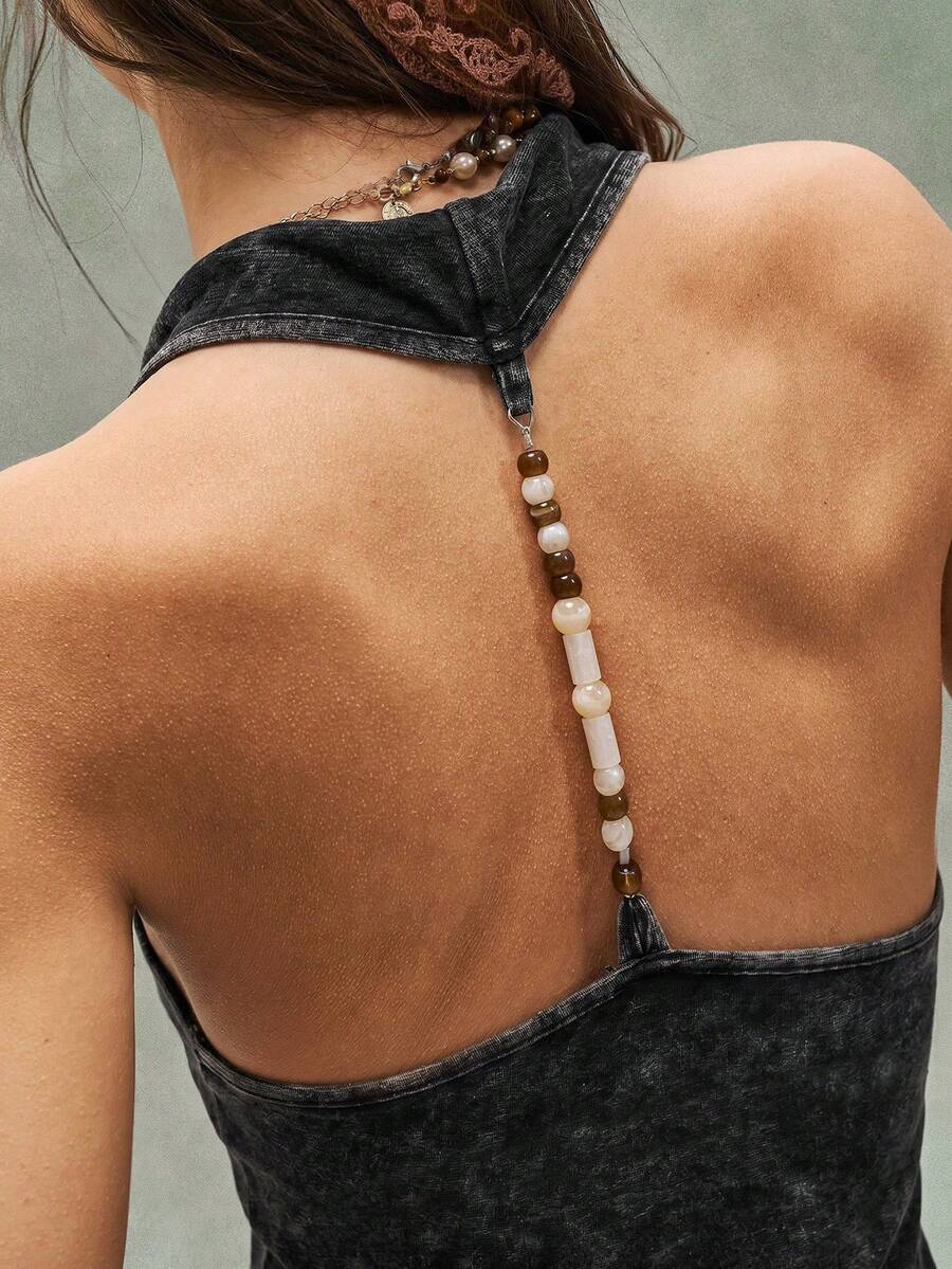Women's casual solid color knit tank top with a backless halter neck design.