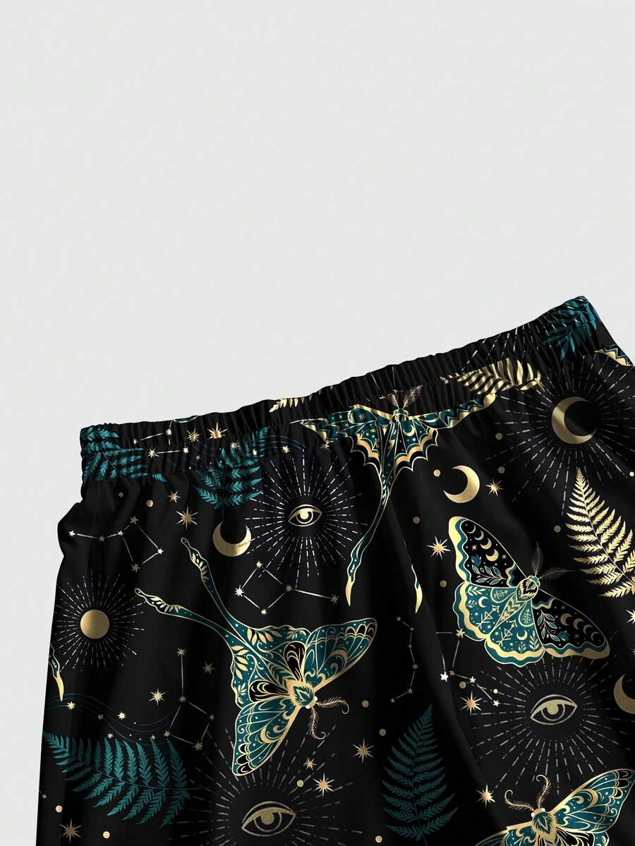 Women's plus size black gothic wide leg pants with split thigh detail and celestial moth, sun, and star pattern.