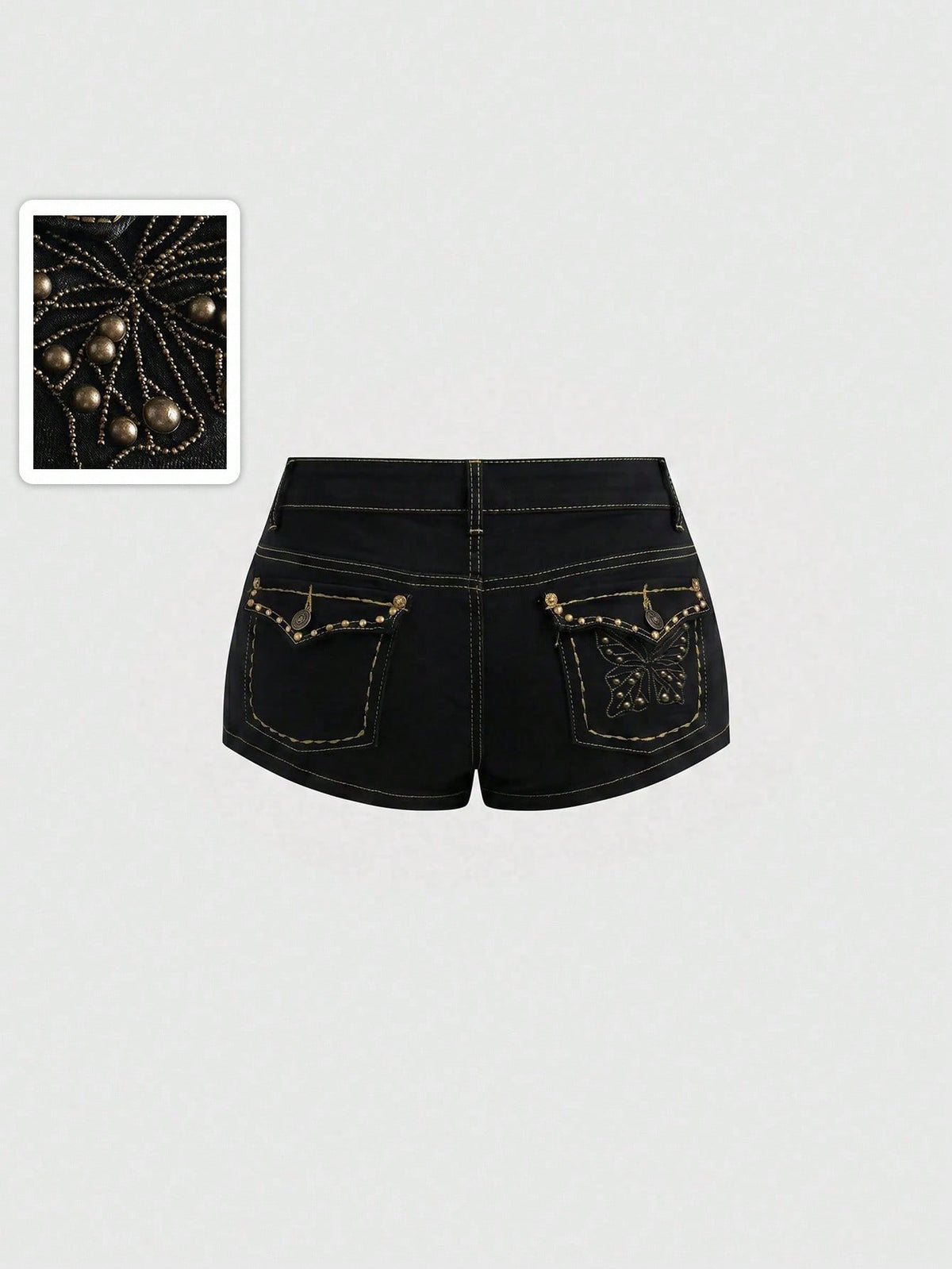 Women's Y2K low waist distressed shorts featuring butterfly studded details, pockets, and a zipper fly closure.
