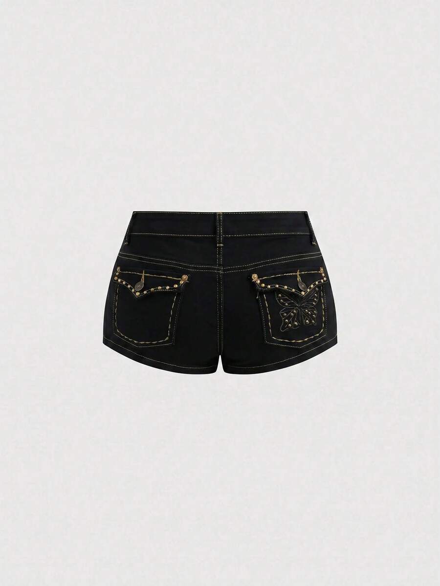 Women's Y2K low waist distressed shorts featuring butterfly studded details, pockets, and a zipper fly closure.