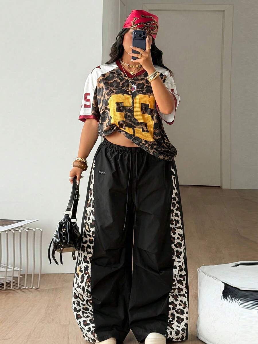 Women's high waist wide leg pants in black featuring leopard print patchwork details and an elastic drawstring waistband.