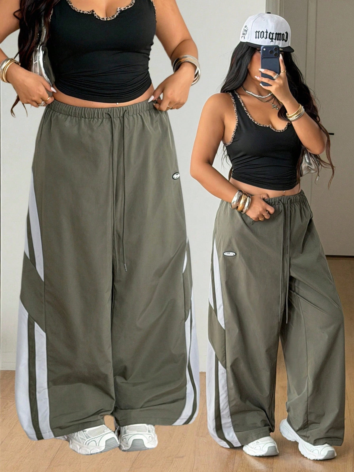 Women's plus size loose straight leg pants featuring a black and white color block design with side stripes and an elastic drawstring waist.