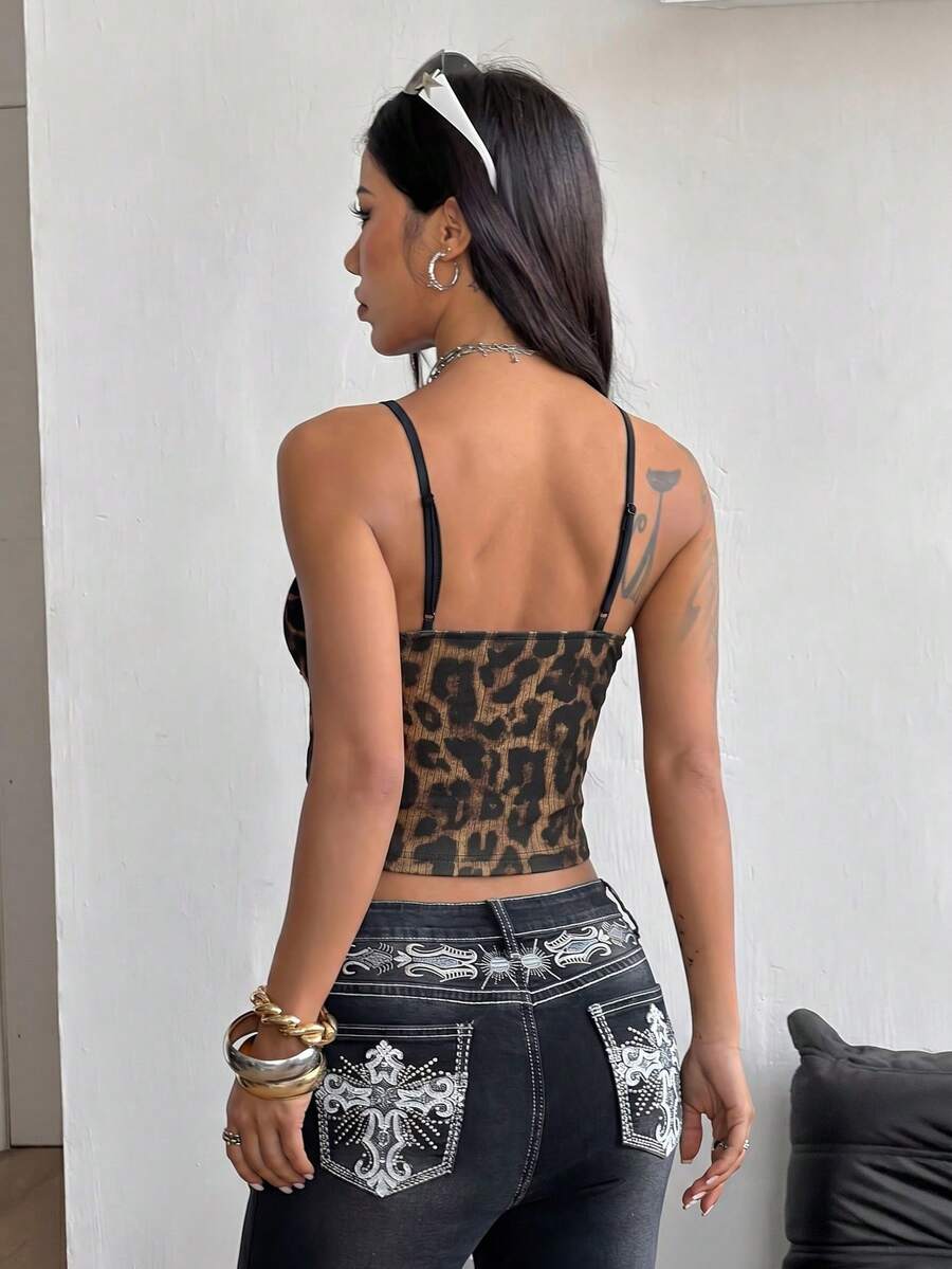 Women's black lace crop cami top featuring spaghetti straps, cold shoulder sleeves, and a sheer backless design.