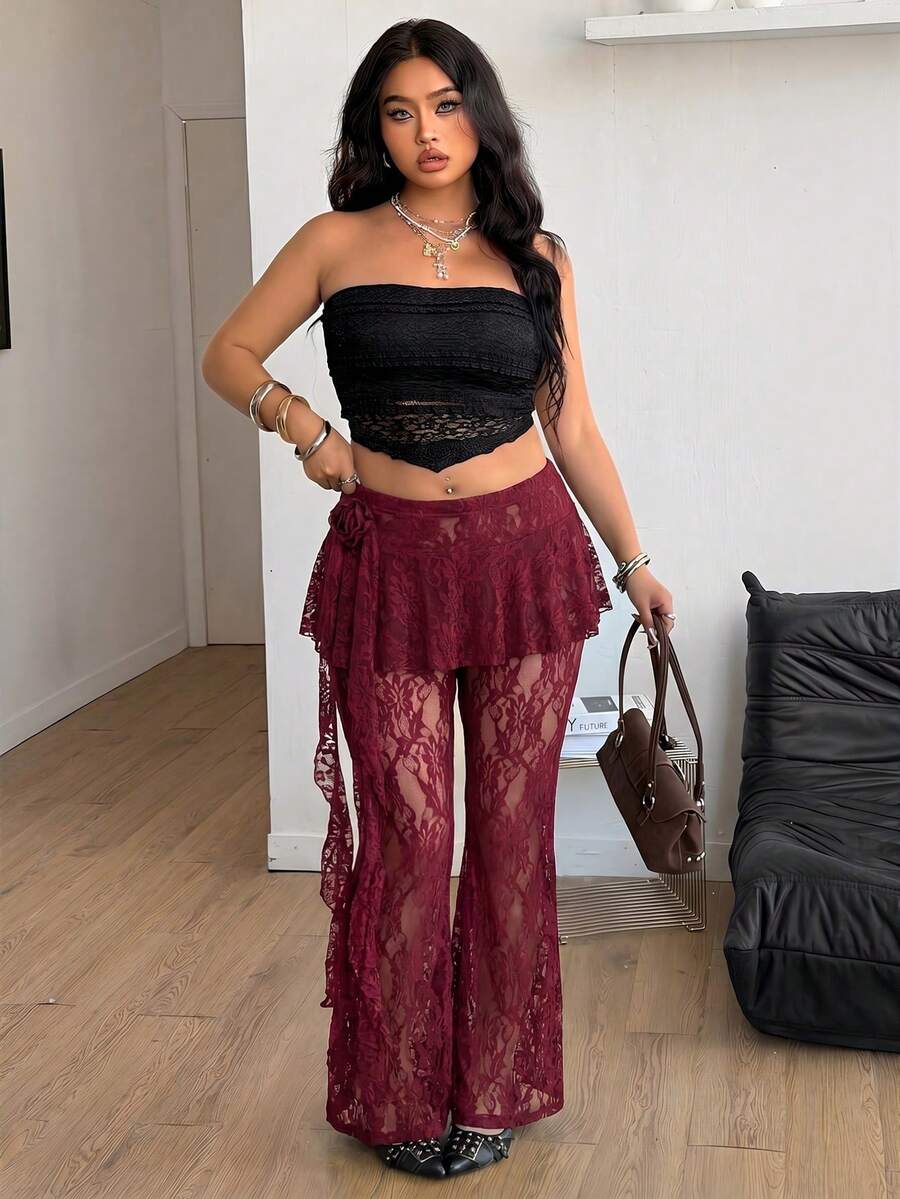 Black high-waist flare leg pants featuring contrast lace trim, floral ribbon detail, and semi-sheer knitted fabric.