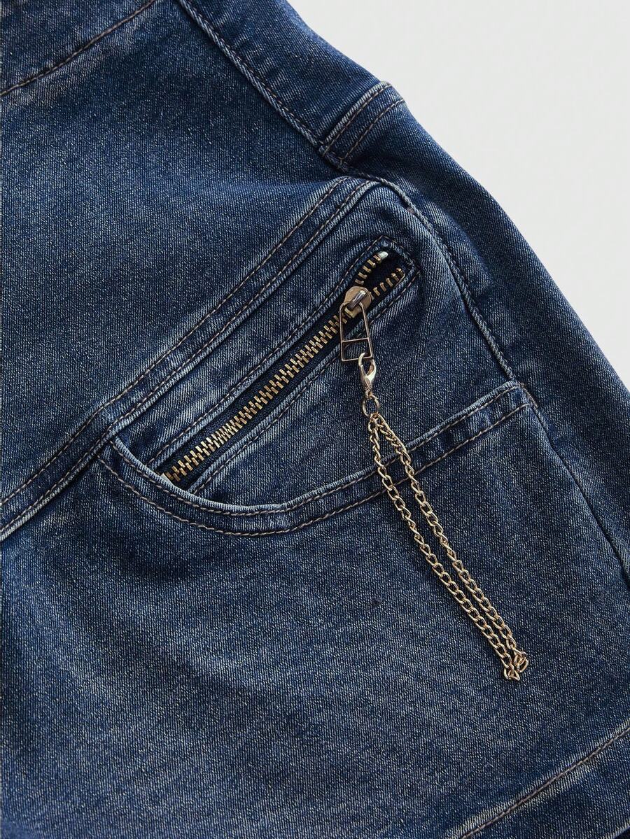 Ultra low-rise stretch denim mini shorts featuring a metal chain with cross pendant and rhinestone detailing.