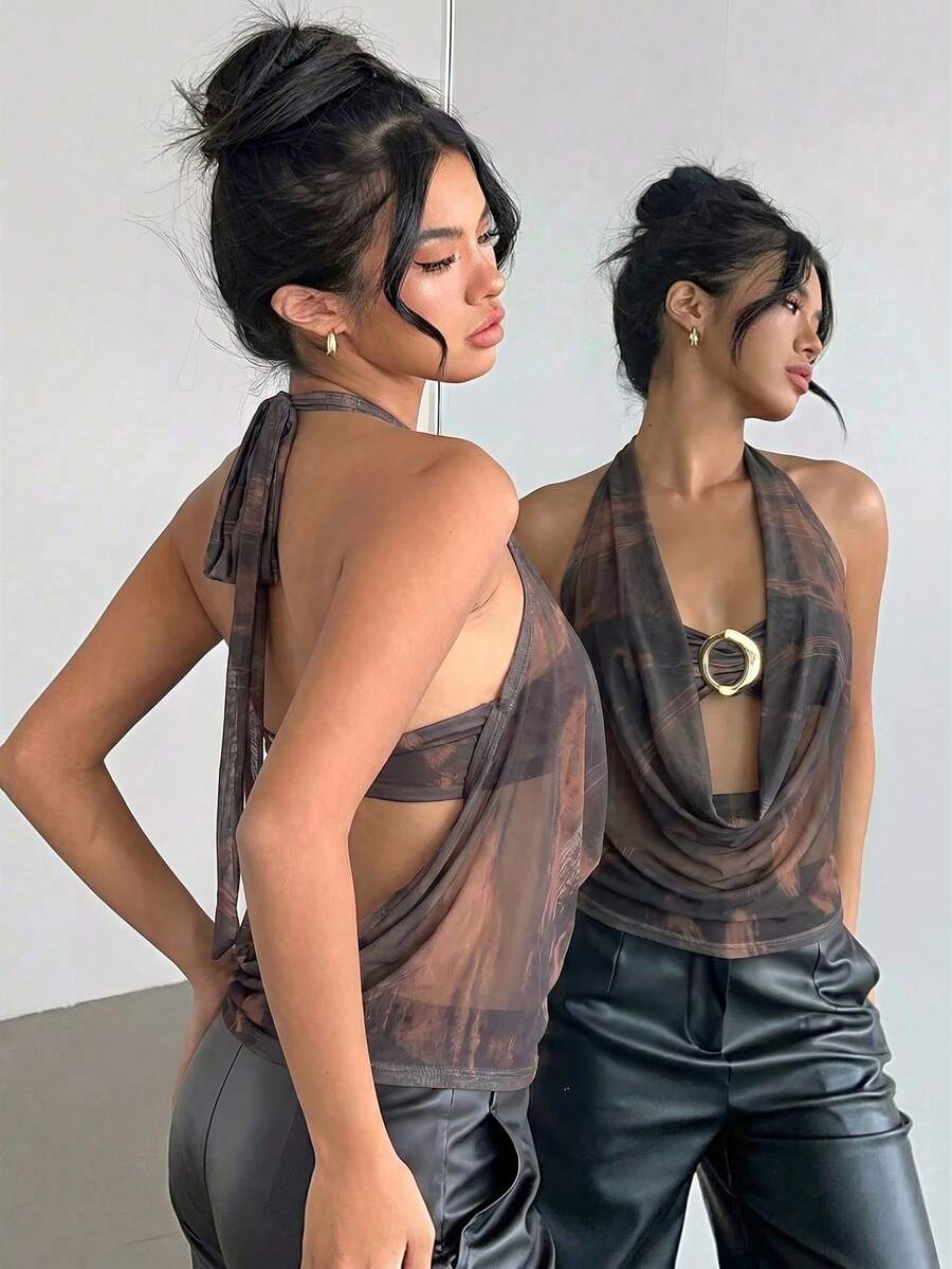 Brown and white polka dot semi-sheer halter camisole top with a plunging neckline, backless design, draped front, and metallic studded embellishments.