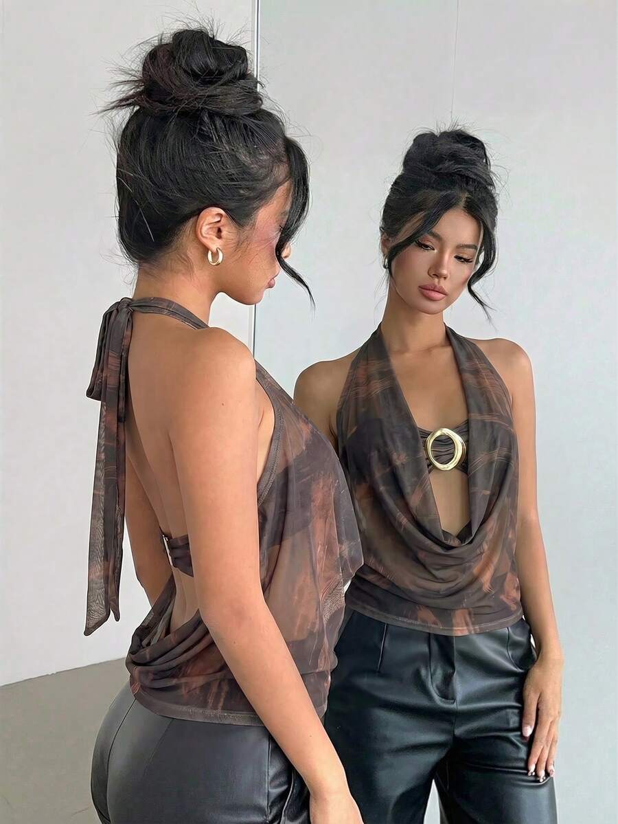 Brown and white polka dot semi-sheer halter camisole top with a plunging neckline, backless design, draped front, and metallic studded embellishments.