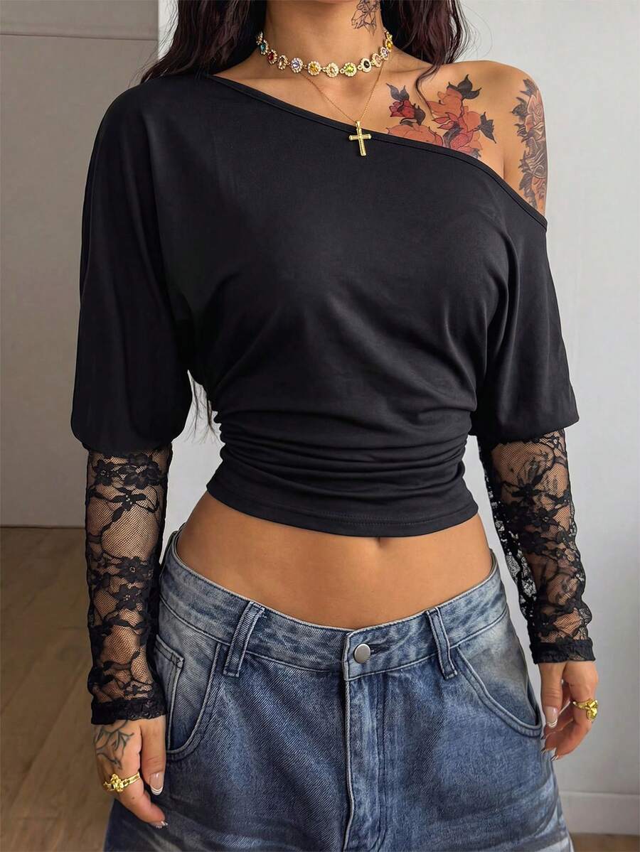 Women's black long sleeve t-shirt featuring delicate contrast lace details and a boat neckline in a knitted stretch fabric.