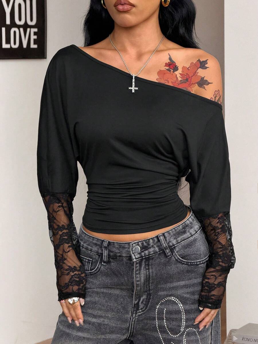 Women's black long sleeve t-shirt featuring delicate contrast lace details and a boat neckline in a knitted stretch fabric.