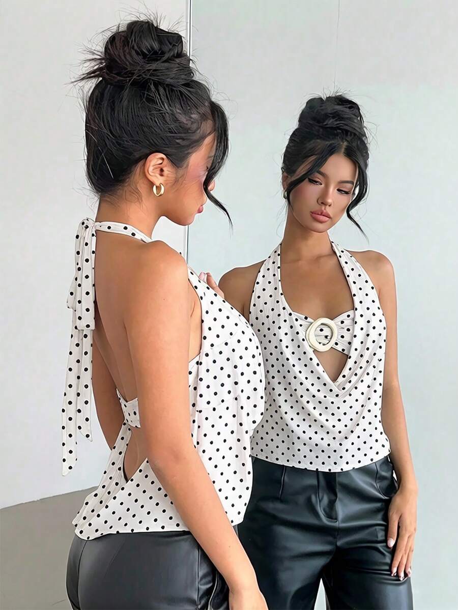 Brown and white polka dot semi-sheer halter camisole top with a plunging neckline, backless design, draped front, and metallic studded embellishments.