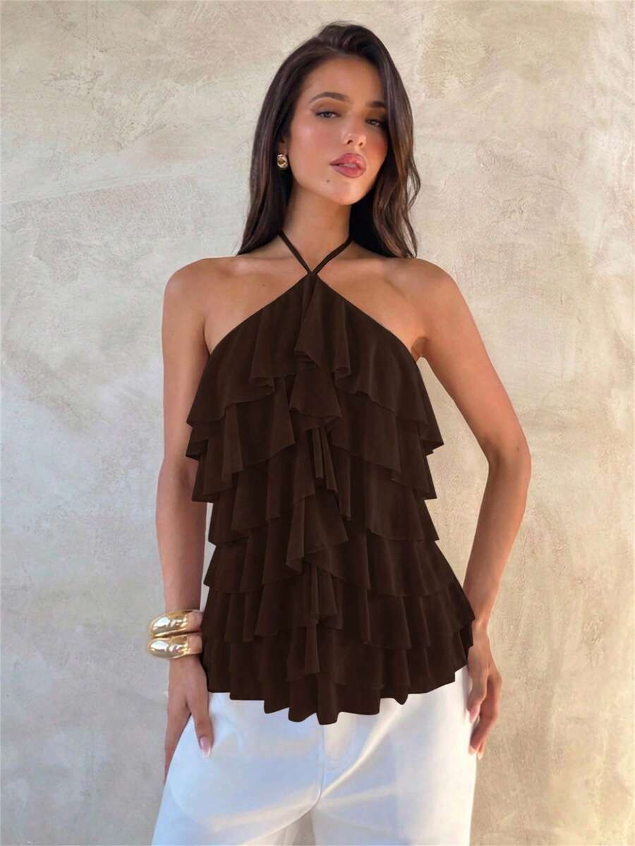 Women's sleeveless halter neck top featuring tiered ruffle layers, a backless cut, and an asymmetrical hem.