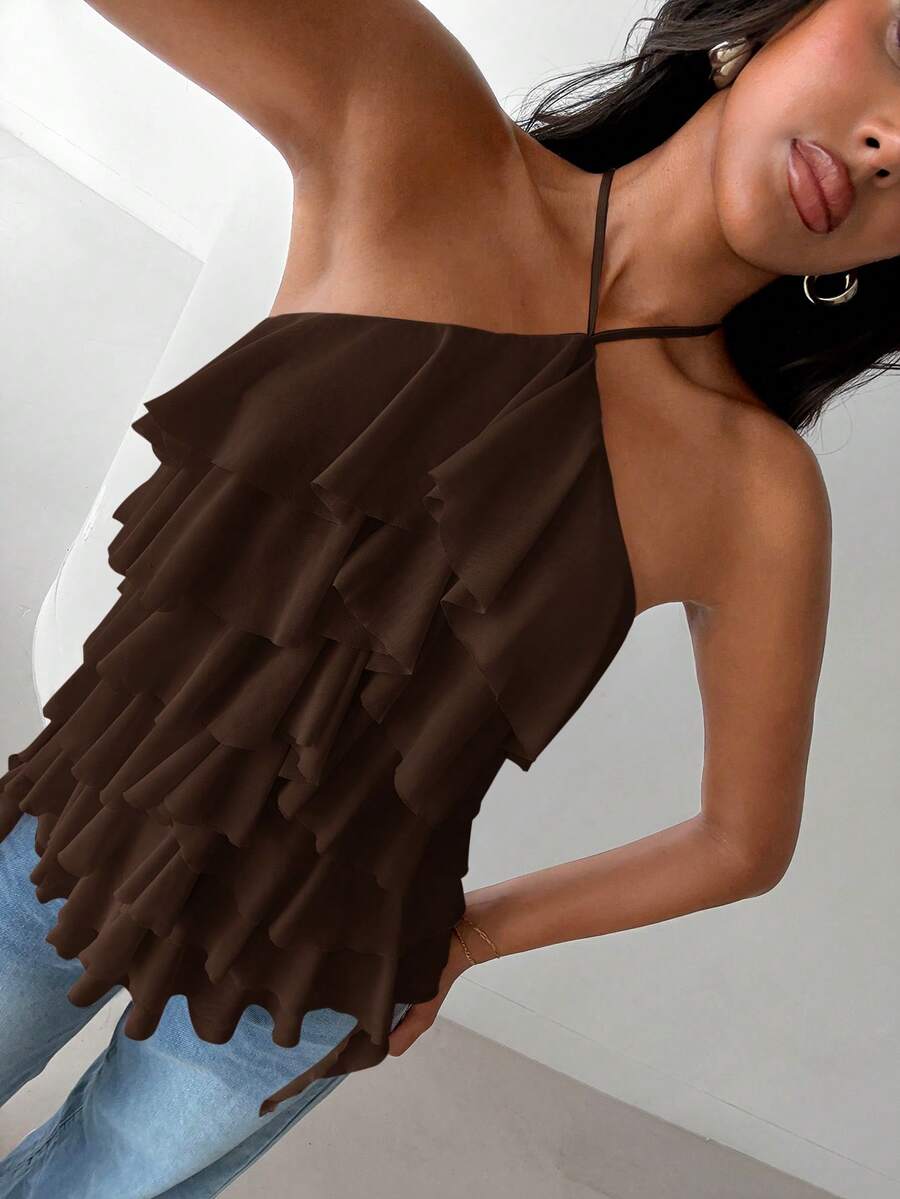 Women's sleeveless halter neck top featuring tiered ruffle layers, a backless cut, and an asymmetrical hem.
