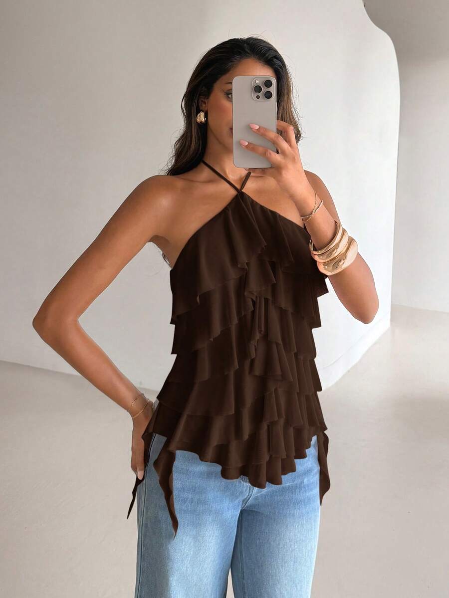 Women's sleeveless halter neck top featuring tiered ruffle layers, a backless cut, and an asymmetrical hem.