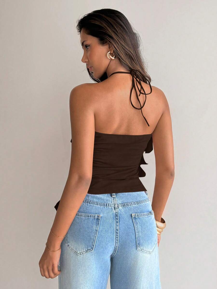Women's sleeveless halter neck top featuring tiered ruffle layers, a backless cut, and an asymmetrical hem.