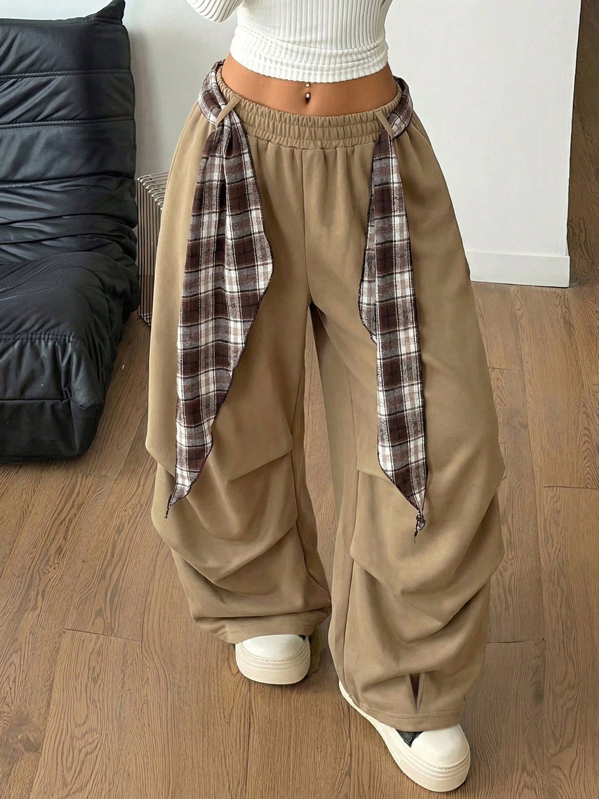 Loose-fitting black baggy parachute pants featuring an elastic drawstring waistband and wide-leg cut made from cotton blend fabric.