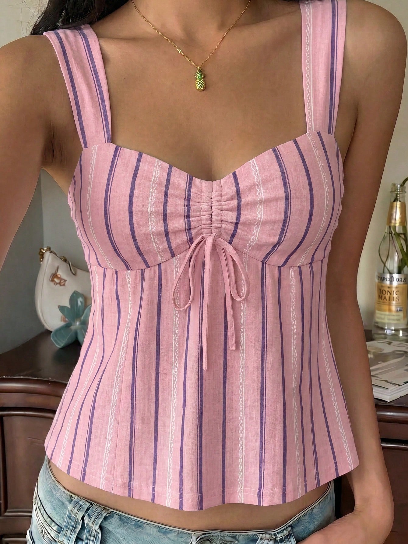 Women's striped camisole tank top with strap neckline, backless knot detail, cold shoulder styling, slim fit, and flared hem for casual vacation or daily wear.