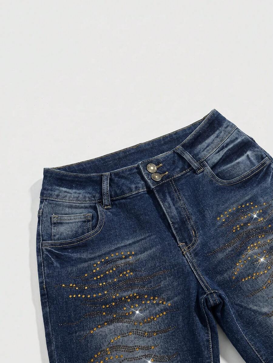 Women's ultra low-rise skinny denim shorts featuring sparkling gold rhinestone embellishments with front pockets and zipper fly.