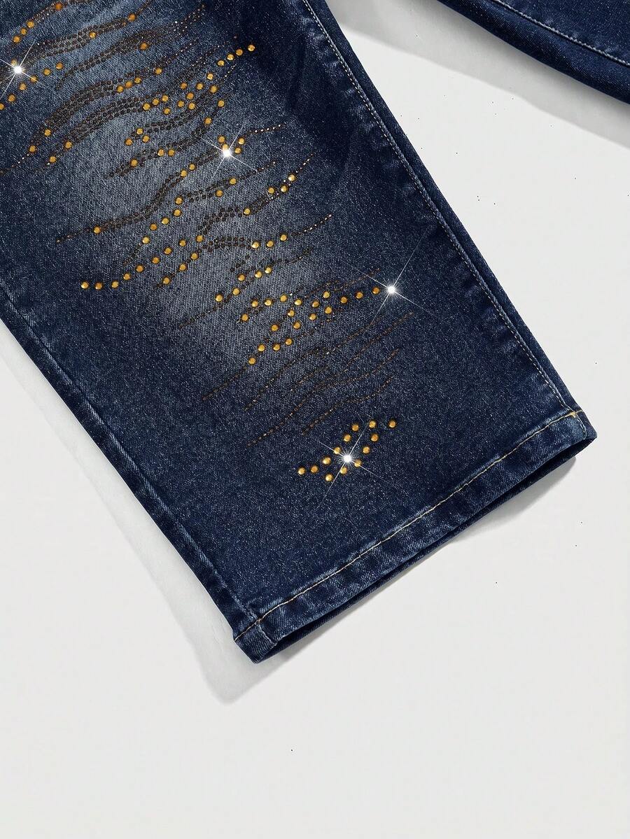 Women's ultra low-rise skinny denim shorts featuring sparkling gold rhinestone embellishments with front pockets and zipper fly.