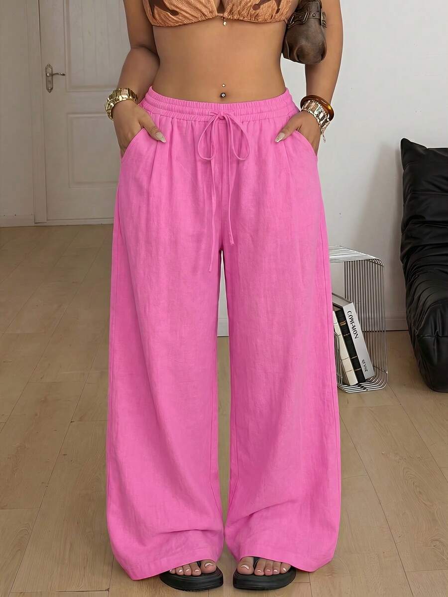 Plus size women's striped loose straight leg cropped pants with pleated detailing and side pockets