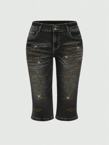 Women's ultra low-rise skinny denim shorts featuring sparkling gold rhinestone embellishments with front pockets and zipper fly.