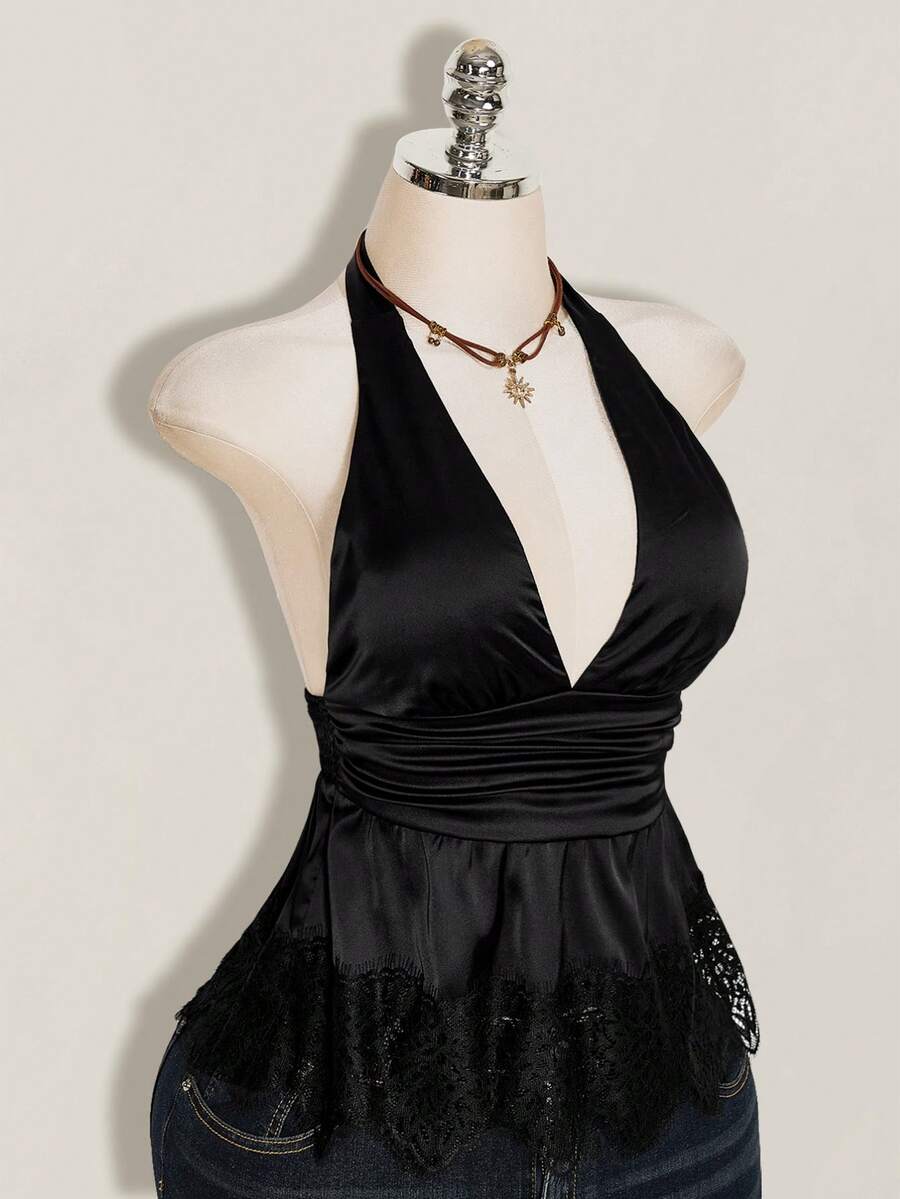 White women's deep V-neck halter tank top with ruched waist, backless design, rib-knit texture, and ruffle hem