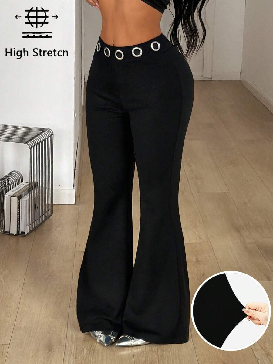 Women's black stretchy mid rise flare pants with grommet eyelet detailing along the legs.