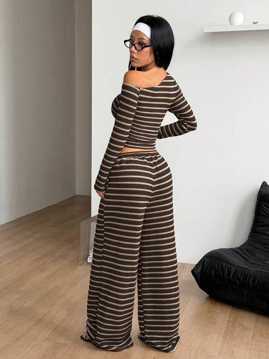 Women's two-piece striped knit tracksuit set featuring a brown asymmetrical neckline long sleeve crop top and matching high-waisted wide leg sweatpants.