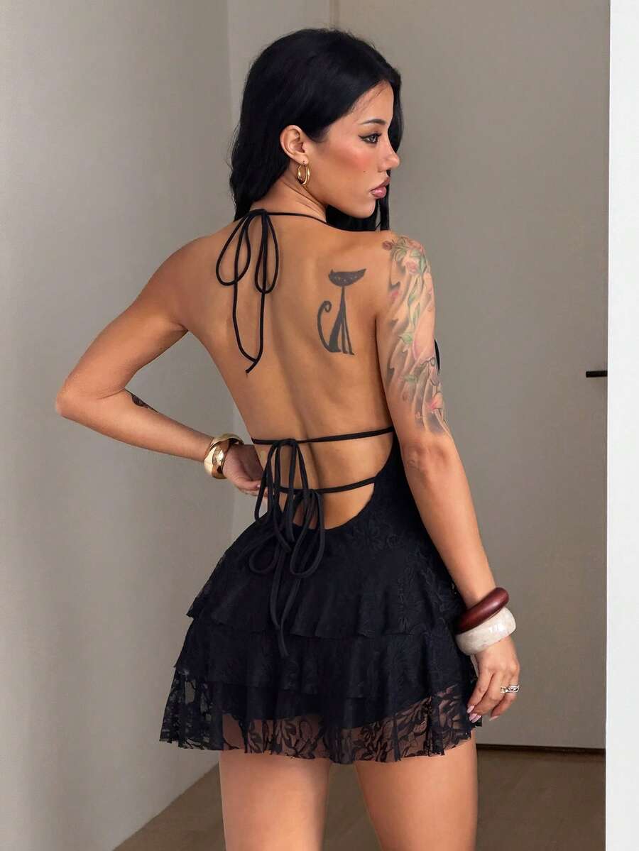 Front view of a women's lace halter mini dress featuring a slim-fit bodice, flared hem, and sleeveless design.