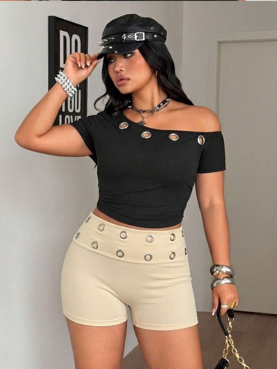 Women's black studded mini shorts crafted from stretch knitted fabric featuring an elastic waistband and skinny fit.