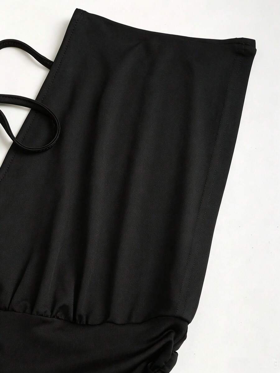 Women's black knitted t-shirt featuring a reversible deep v-neckline, batwing cap sleeves, ruched detailing, and a slim fit waist.