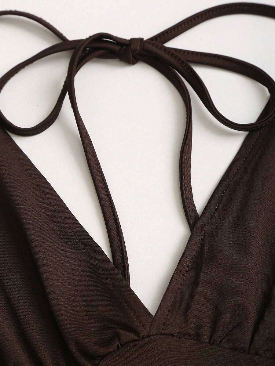 Women's black knitted t-shirt featuring a reversible deep v-neckline, batwing cap sleeves, ruched detailing, and a slim fit waist.