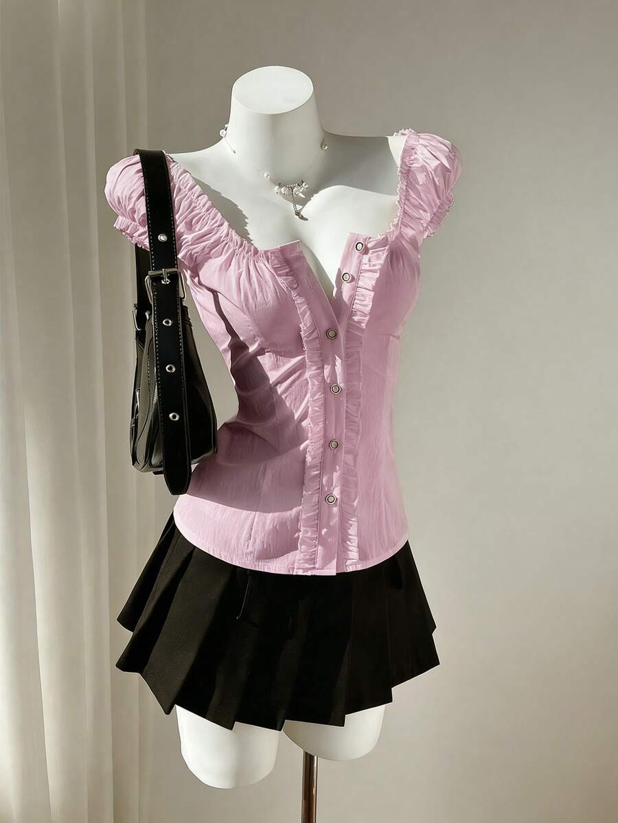 Women's black off-shoulder cap sleeve blouse with ruffled detailing and a tie-back design.