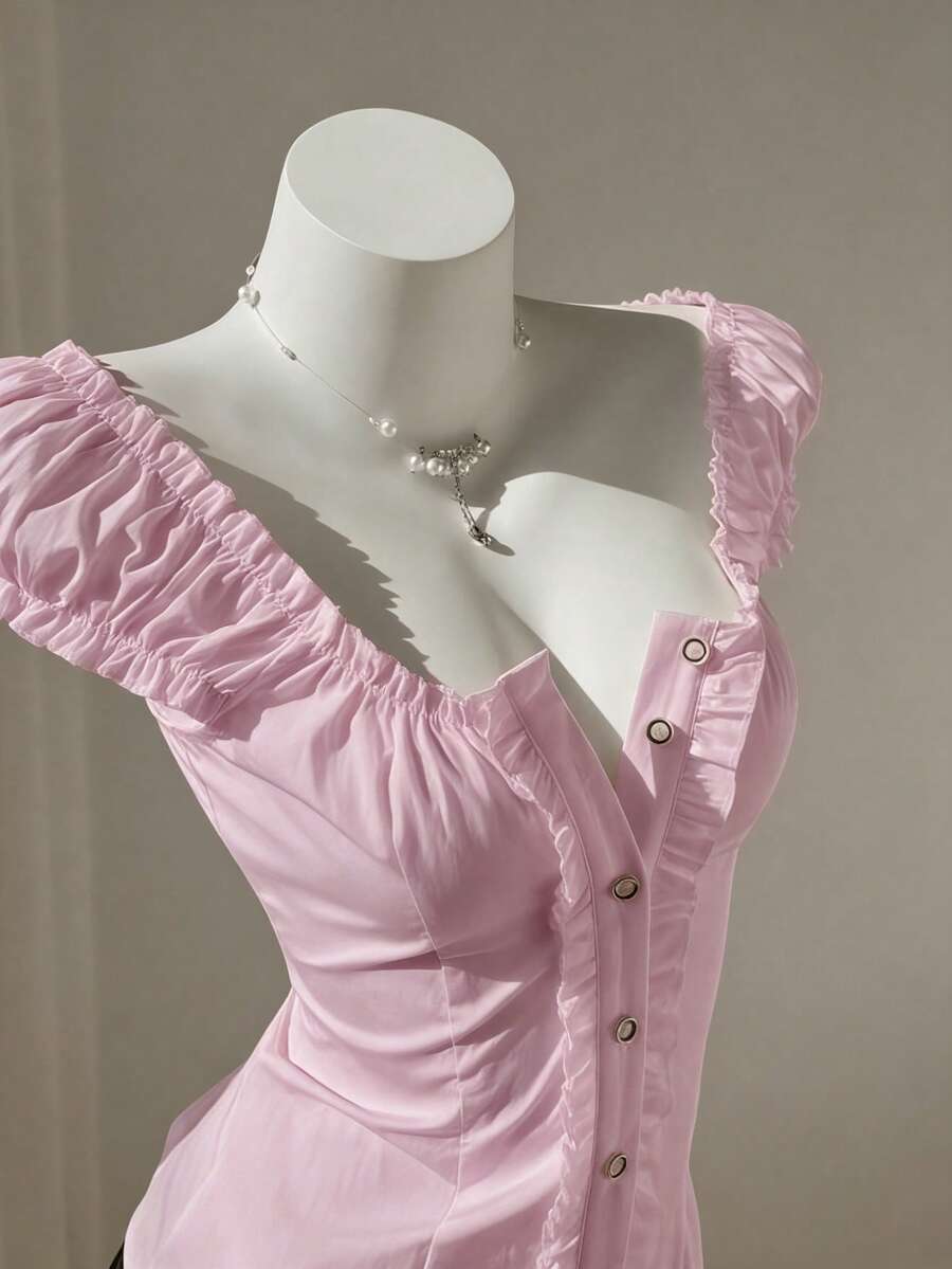 Women's black off-shoulder cap sleeve blouse with ruffled detailing and a tie-back design.